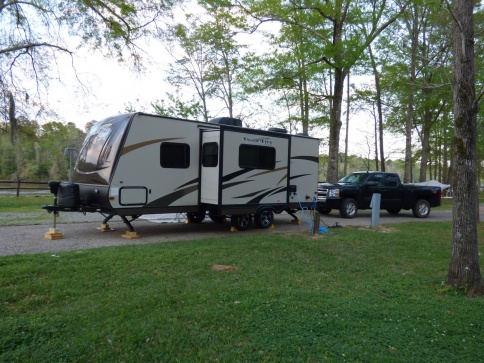 Looking from the road to the campsite.  It is a river front pull through site with water/power there.  They also have bathrooms/showers/laundry/dump s