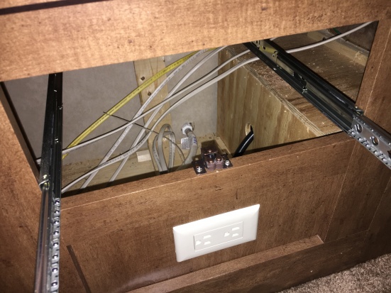 Lots of people talk about "hidden" or "secure" storage.  You could hide lots of things under drawers and no one would think to look there.

if you wer