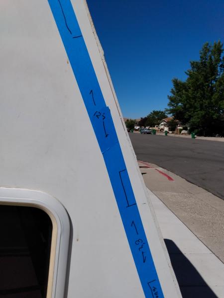 Masking tape showing where framing is for attaching exterior underlayment/luan