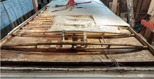 More sheathing removed from the front. Everything removed so far was wet and rotted. The ceiling paneling has dislodged from the trusses in the front 