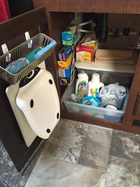 Mounted Command Hooks under the kitchen sink cabinet door to hang my cutting boards and storage basket for cleaning items. Also, I use a magazine rack