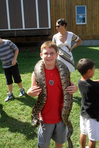 my brave son with a boa constrictor at reptile day