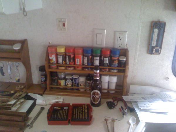 My extra large spice rack attached to wall by stove.