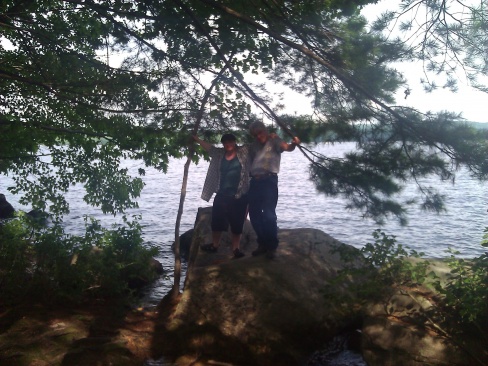 My son and I standing on a huge rock right at the front of our site on Long Lake.