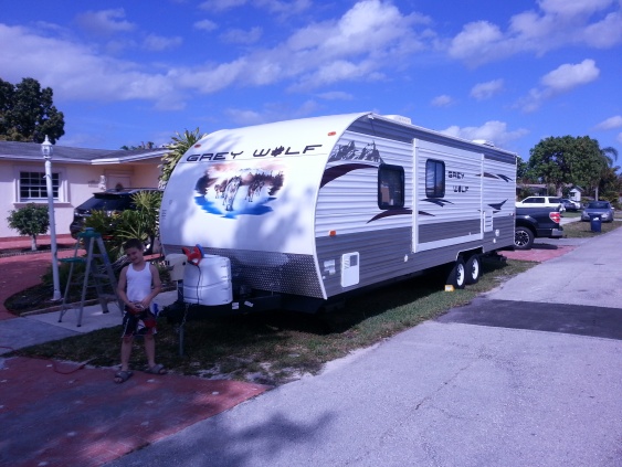 My son standing in front of our trailer as we finished up cleaning it before storing it away from our summer trip to Sebastian Inlet Florida