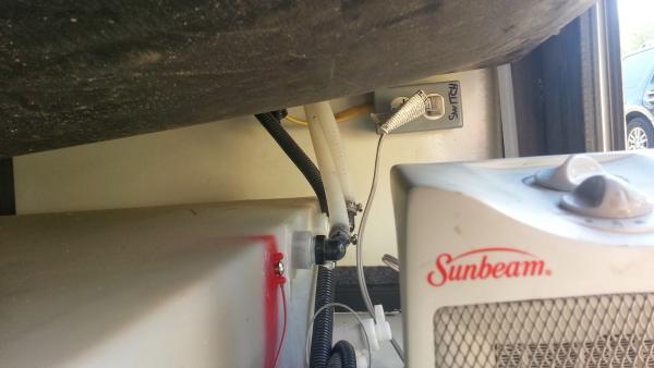 New switched outlet and electric heater behind RH water cabinet access door.