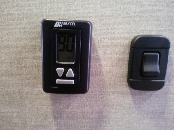 New thermostat design. Bottom button lights up large display.