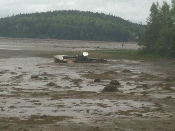 Old boat stuck in the mud, low tide