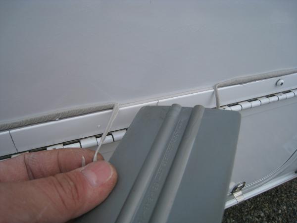 Once you trace around the edge with the plastic squeegee, the butyl tape just peels off and away from the wall.