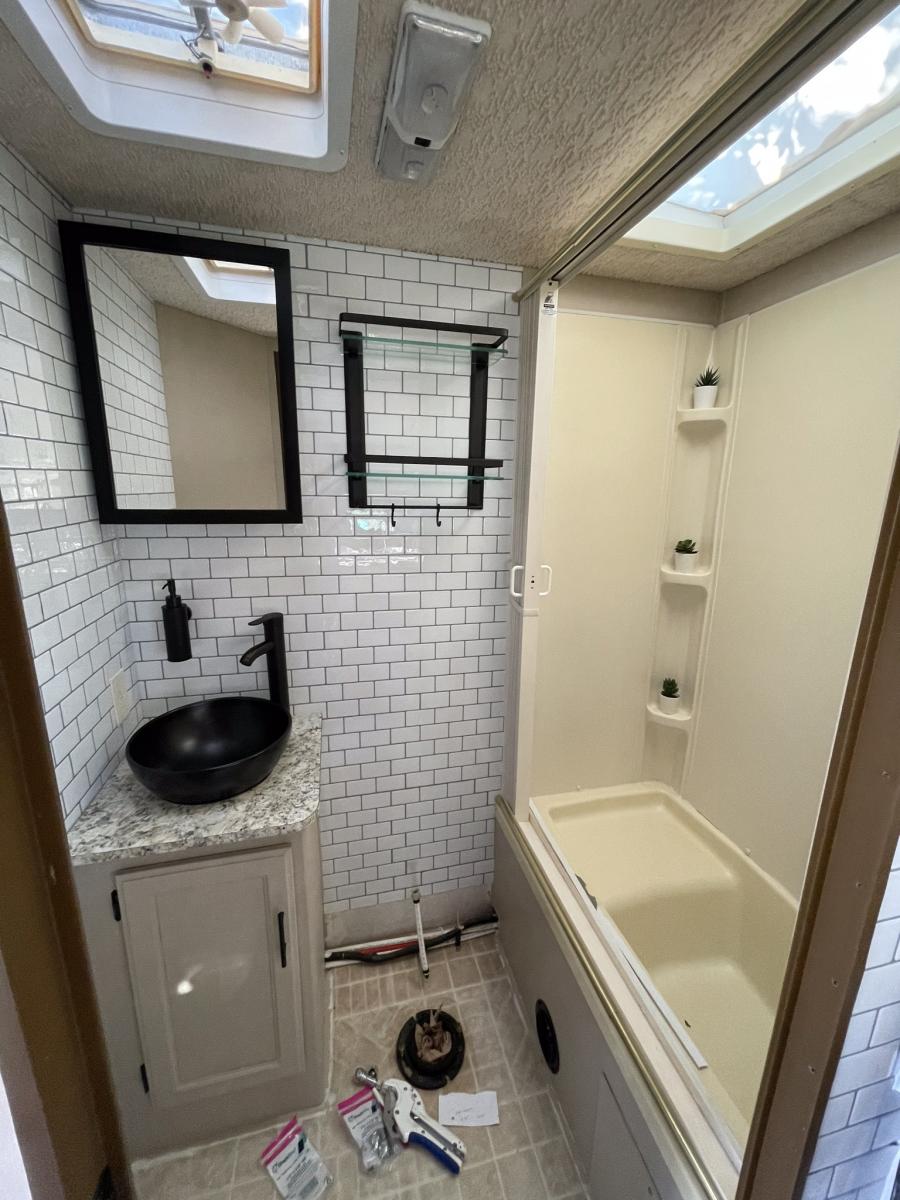 Original bathroom countertop had been ruined by a leaking hairspray bottle - so replaced countertop and sink - vessel mount was a way of being able to