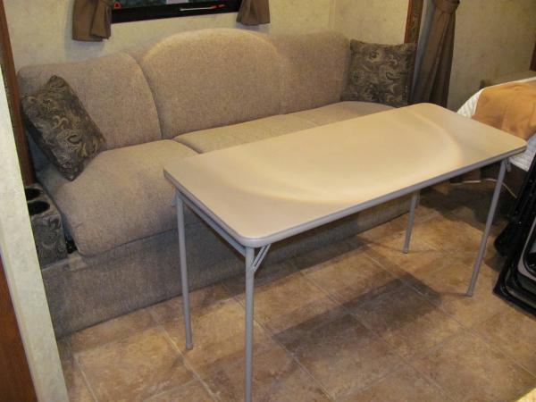 Our much lighter and narrower table by Cosco. 20"X48"

http://www.coscoproducts.com/eng/Products/Indoor-Furniture/Folding-Tables/