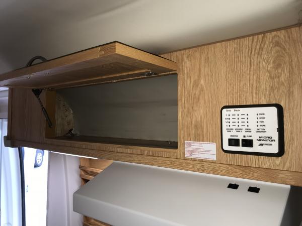 Over galley storage, tank monitors includes battery charge status and fresh water pump switch