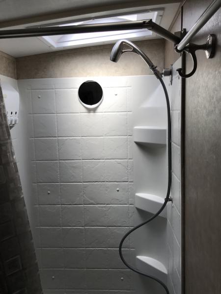 Oygenics shower head and Extend-a-Shower shower curtain rod. Both make for a much nicer shower experience.