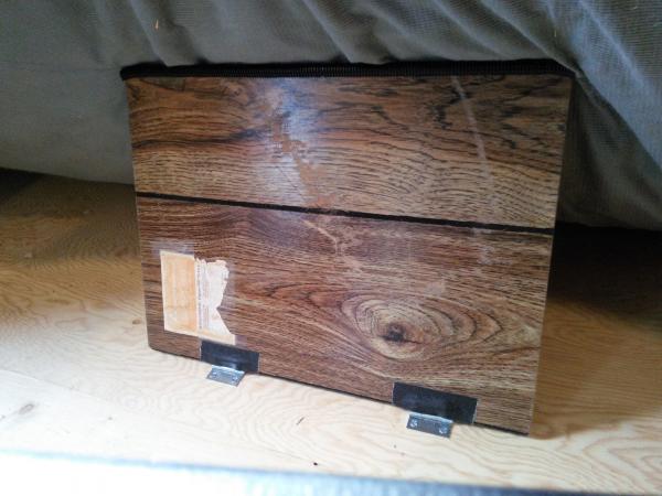 Paneling sample hinged to bed for holding up mattress. It works very well with no storage problems.