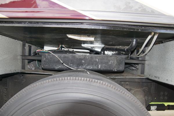 Passenger side wheelwell with gray tank exposed. Inner wheelwell removed to provide access.