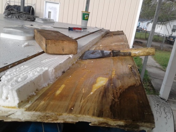 peeling each layer of bad wood off layer at a time...so i could save the underlying roof membrane