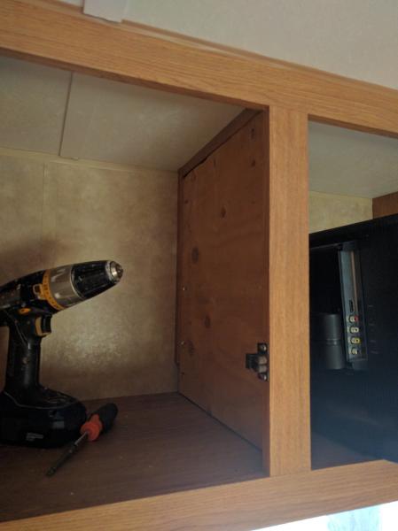 Plywood installed in cabinet (will behind closed door) to reinforce cabinet partition for TV mount.