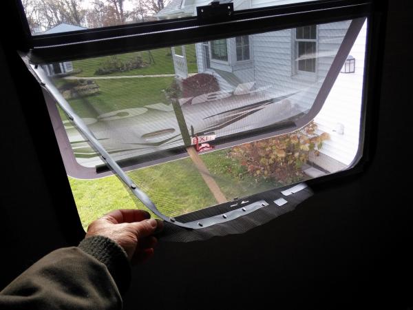 Rear window screen held on with super magnets from Harbour freight.