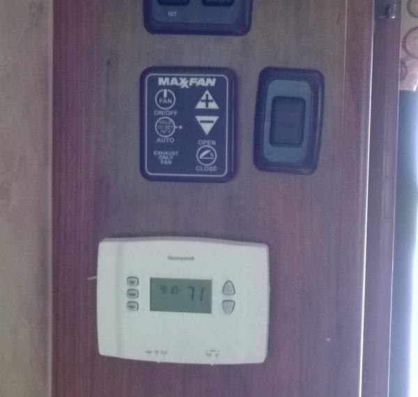 Residential programmable thermostat with high/low fan switch and switch for led step lights.