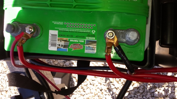 Right side battery.
Positive post has Positive connection to solar, and Positive post of left side battery.
Negative post is connected to Negative pos