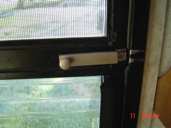 Screen Door Safety Latch, accessible thru sliding panel from outside.