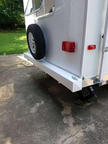 Sewer hose storage bumper made DIY from 5" vinyl fence post.