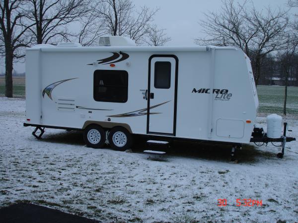 Side view. 2 step entry with 14 inch tires and aluminum lug covers