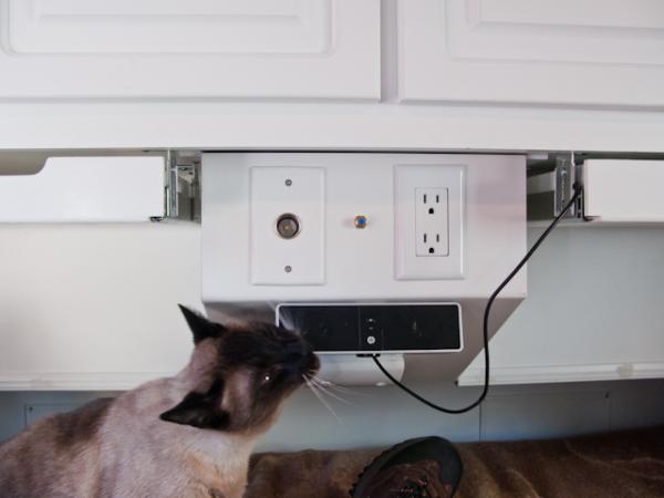 Simon, our tear drop modification inspector, is giving his approval to my addition of speakers, computer shelves under cabinets and coaxial cable out,