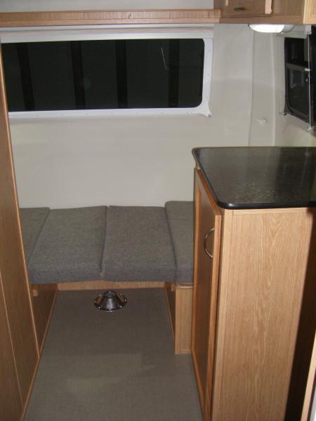 Small dinette in single bed formation.  We have a Costco memory foam topper- I resized a duvet cover to fit it into and it's stored under the seat box