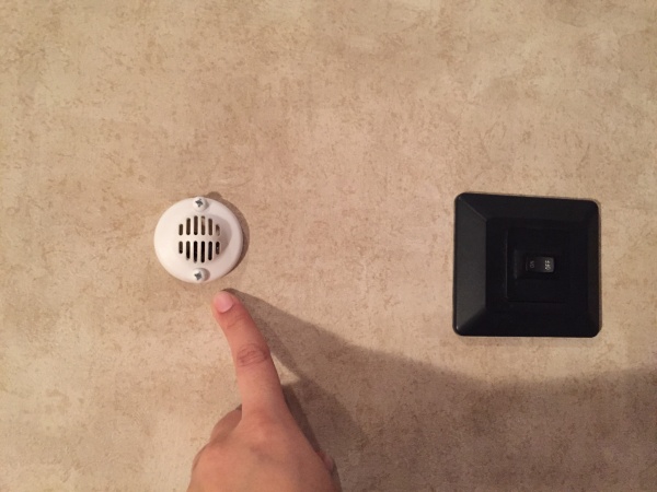 Small round vent above light switch.