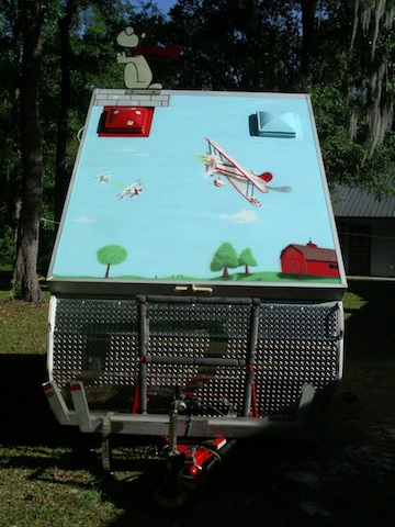 Snoopy battles the skies over WWI Europe. Dome vent is his doghouse.