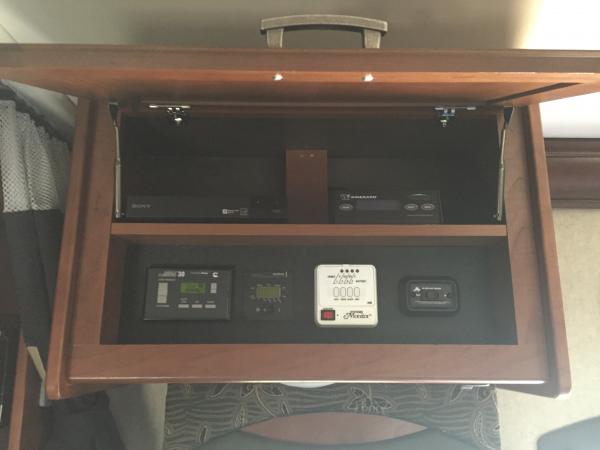 Split the overhead compartment to make room for a shelf for a Blu-Ray player and Winegard controller.