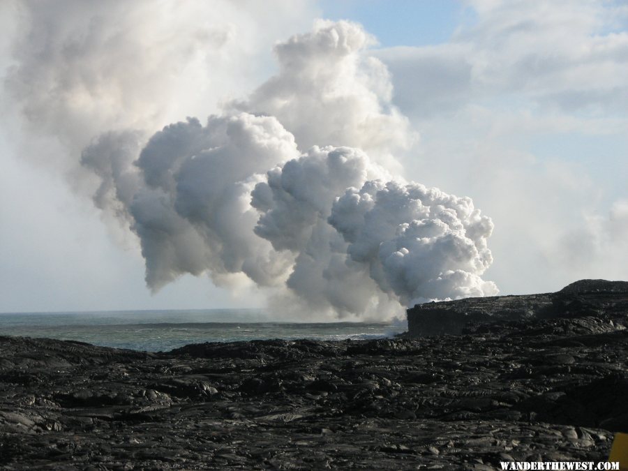 Steam from lava flowing into the ocean.