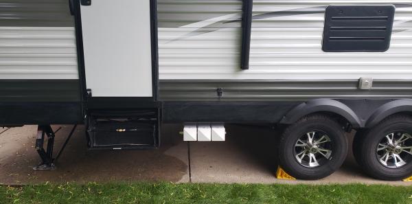 Storage Tubes 2 - The tubes are mounted between the rear wheel and the steps to the back door.