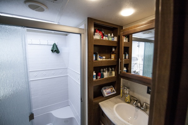 The bathroom with full size shower and plenty of storage.