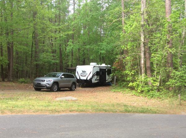 The Jeep and the Whitehawk 23MRB sitting back in a very private and wooded spot.