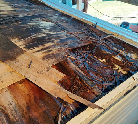 The plywod sheathing is saturated with water. Mysterious because the saturation extends well "uphill" from the caulked and re-caulked termination bar 