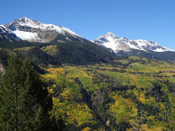 The San Juan Skyway between Dolores and Telluride, Colorado when the fall colors are at their peak. A recent snowfall in the mountains helped to compl