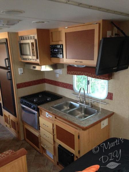 The trailer had had very little done to it in six years. 
 I attached a paper towel holder to the wall and command hooks beside the stove for coffee c