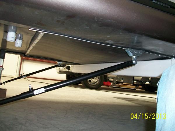 The two front to back stabilizers measure out to be located at the under storage door area.  You can remove the plastic insert at the door of the unde