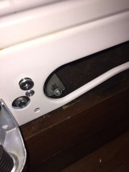 There is one screw on each side of the fridge bottom which anchors it to the floor.  Remove both with the freezer door open and kickplate removed.