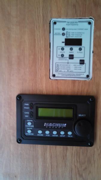 These are my battery monitor on top and my inverter/charger remote on the bottom.  I decided to locate these in the wall of my entertainment center, t