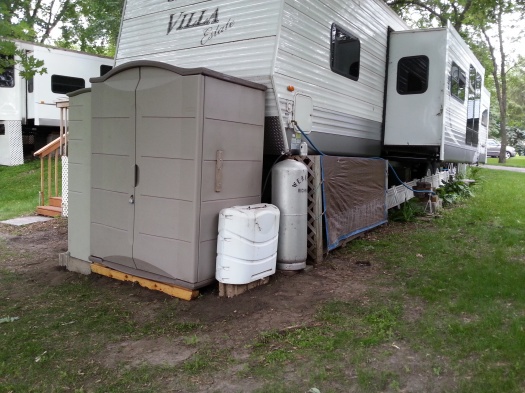 This shows the propane tanks relocated to the right of the sheds.