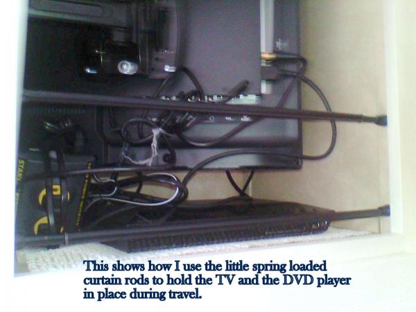 This shows the way I use the spring loaded curtain rods to hold the TV and the DVD player in place while traveling.  The DVD player is sitting on one 