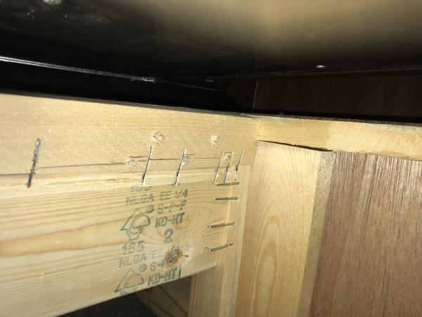 Thor's crappy installation of bed slide rollers.  The entire piece of wood was twisting because it was soft pine/fir and only held together with stapl