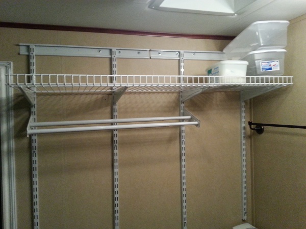 Towel drying rack and storage in bathroom.