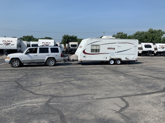 Truck and Camper leaving Dealership