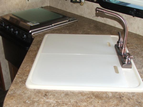 Two cutting boards my husband trimmed down to fit my sink so I could have two on sink instead of the big one that came with it.