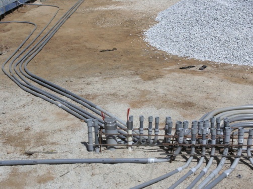 under slab electric conduits shown prior to sand cover , moisture barrier and capillary break install. They are running to strategic locations through