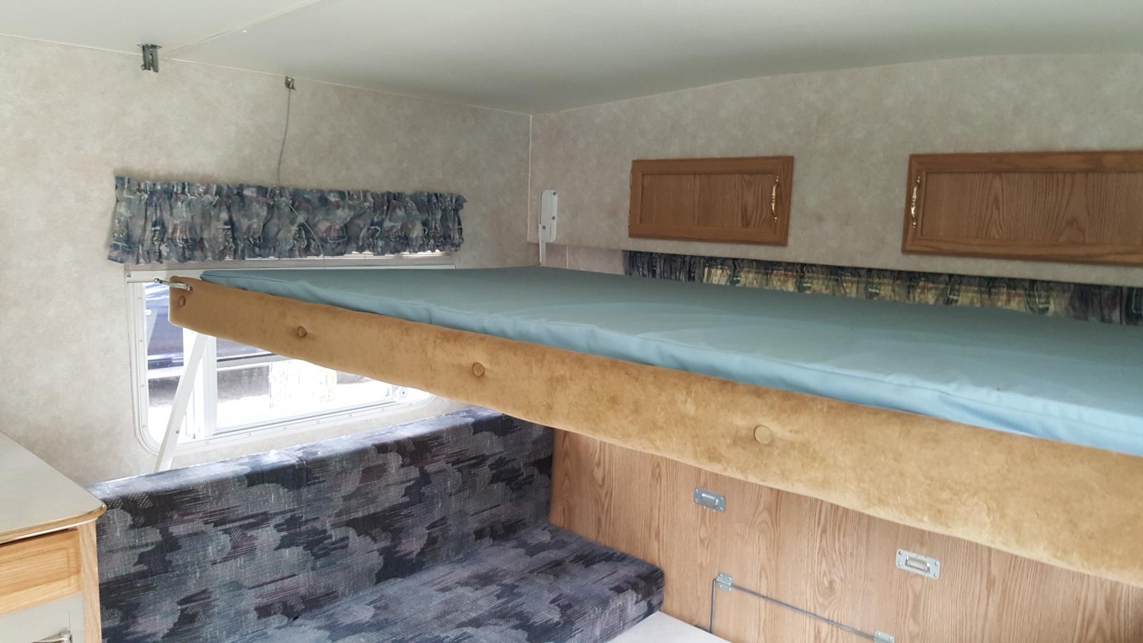 Upper bunk over large table (converts to Queen bed)